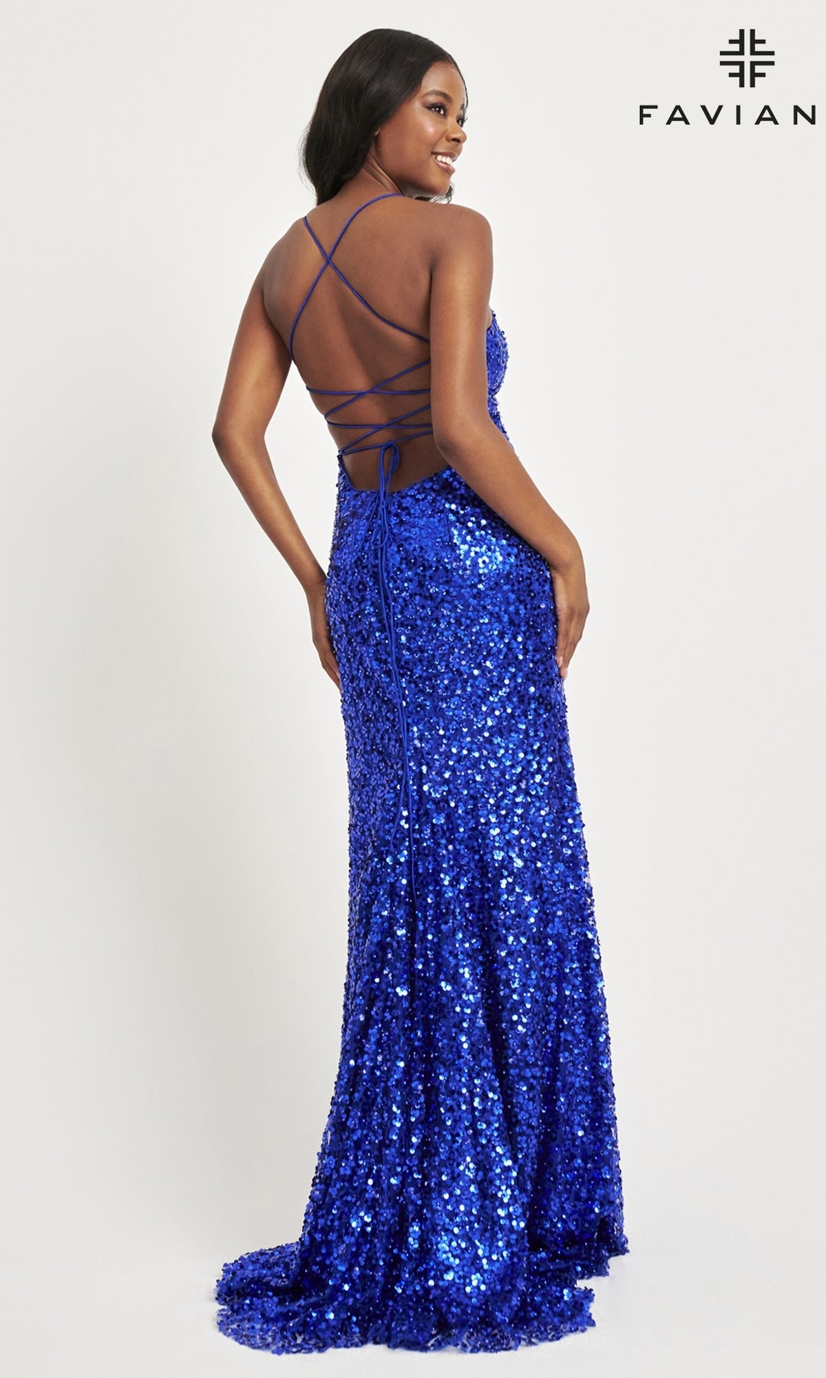 A woman in the Faviana Empire-Waist Long Sequin Prom Dress 11033, featuring a bright blue color and crisscross open back, poses looking over her shoulder. The FAVIANA logo appears in the top right corner.